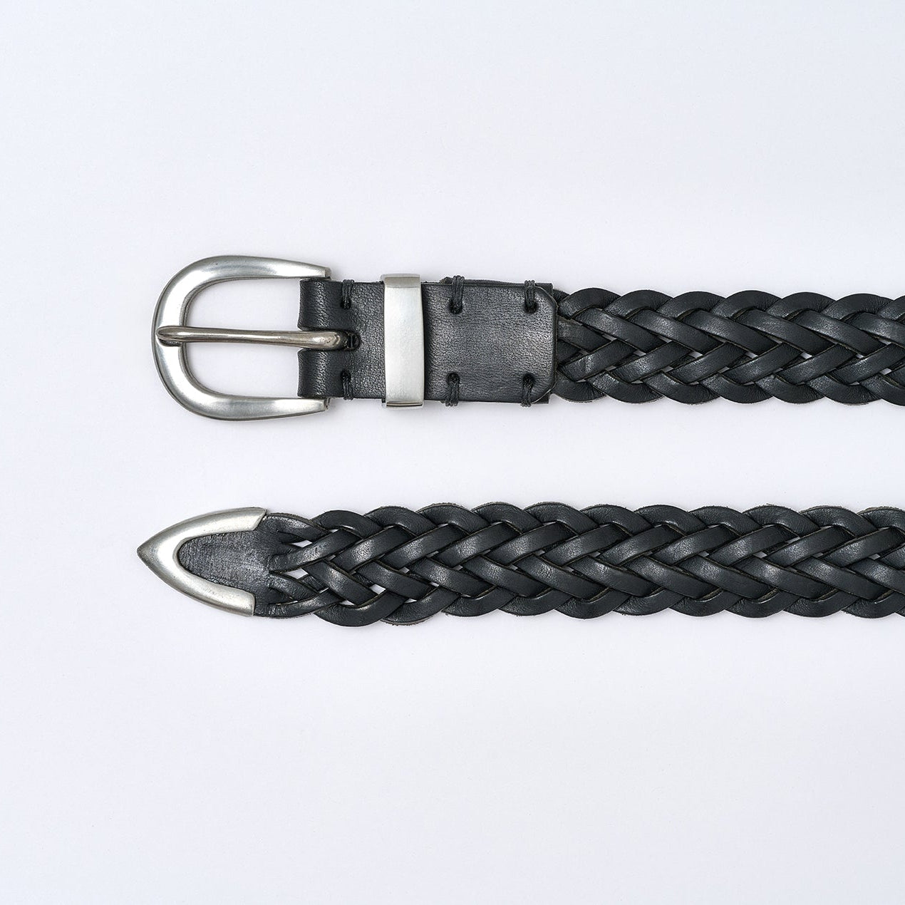Black braided belt with silver buckle on a light gray background