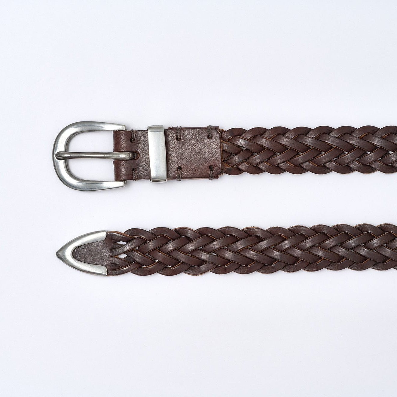 Brown braided belt with silver buckle on a white background