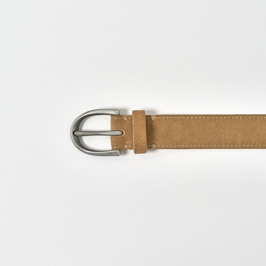 Brown belt with silver buckle on a light gray background