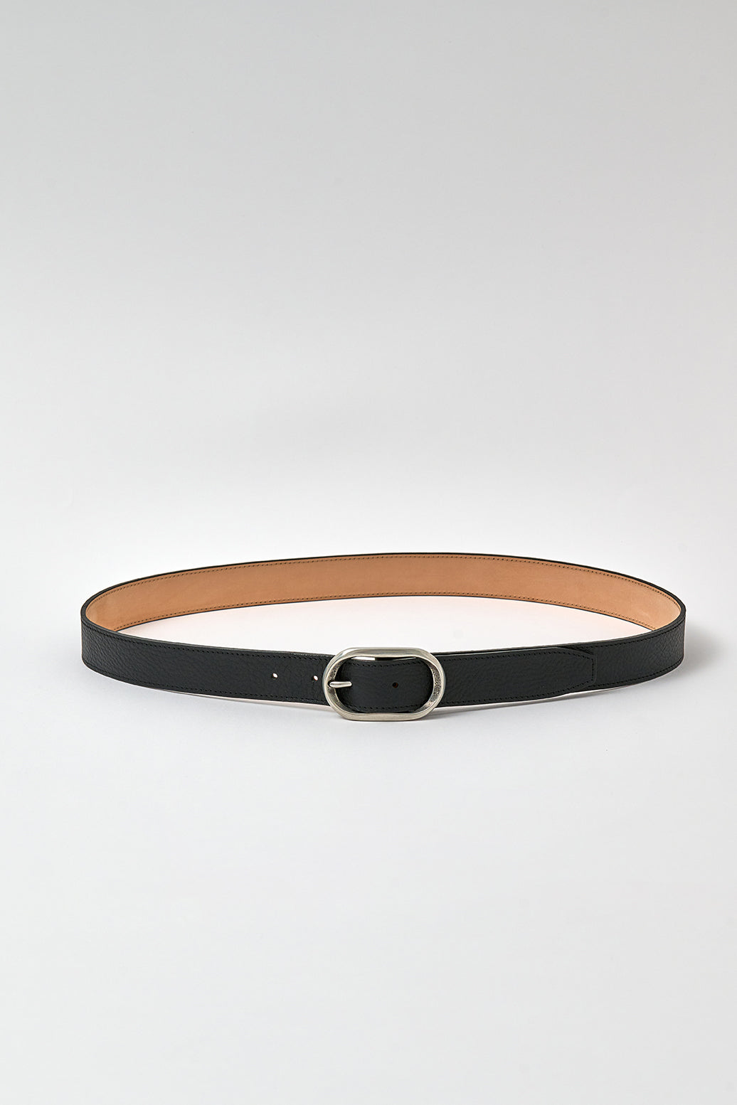 Black belt with a silver buckle on a light gray background