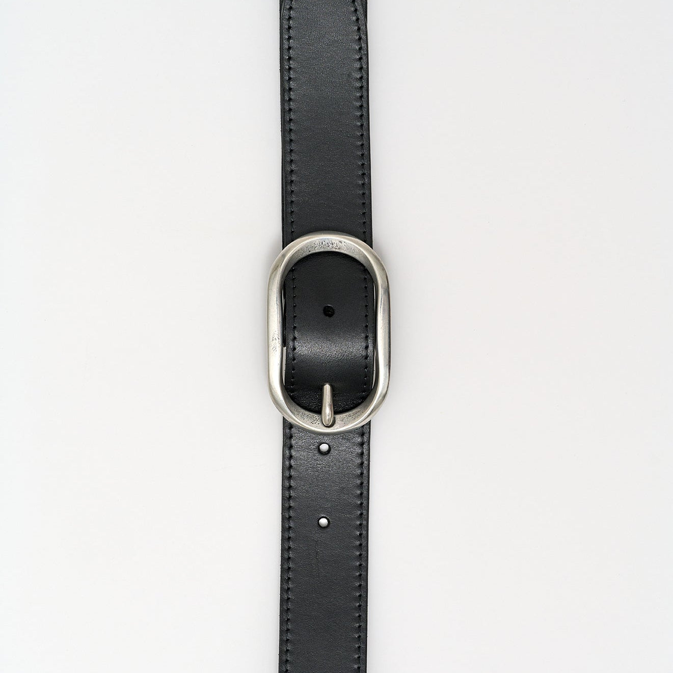 Black leather belt with a silver buckle on a white background