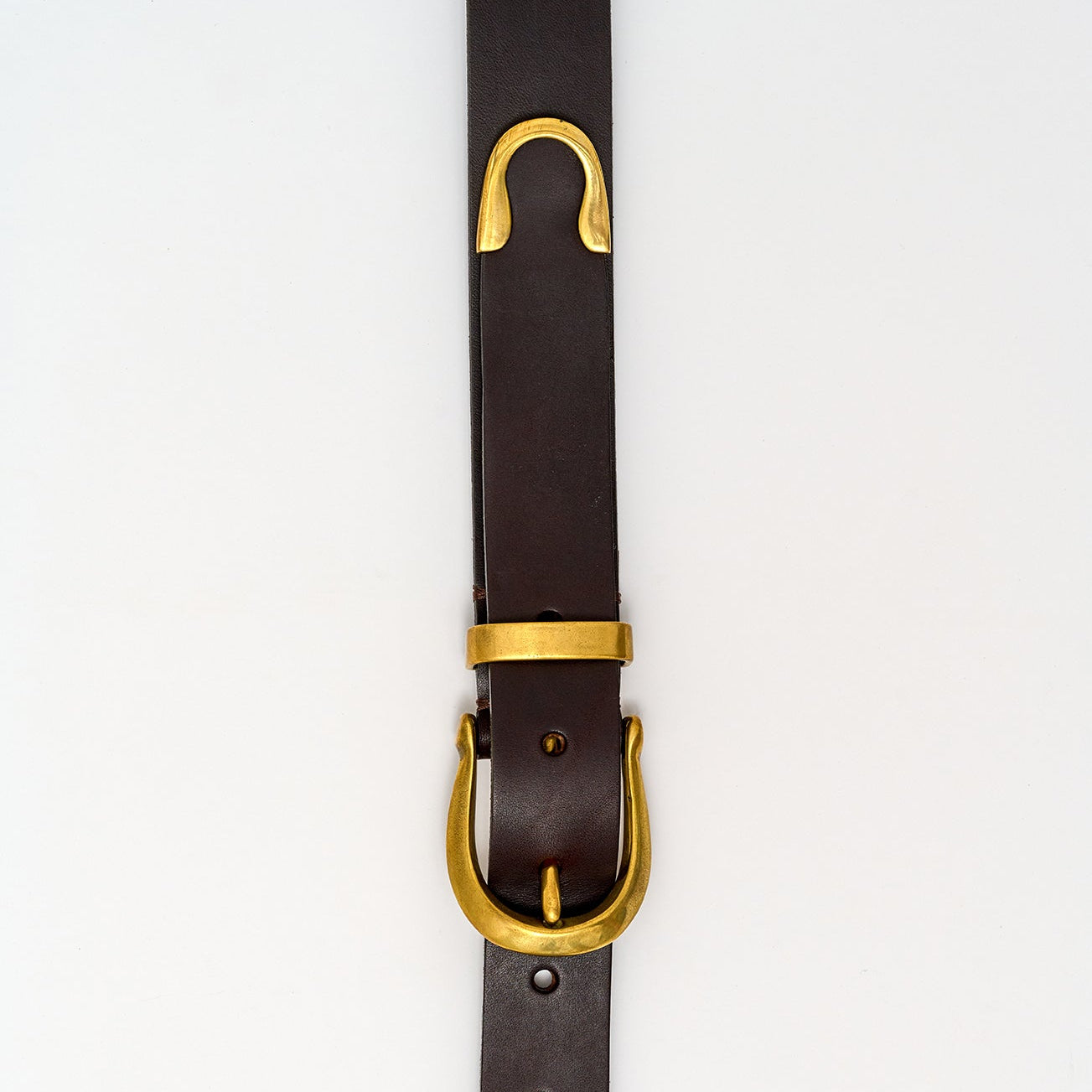 Black leather belt with a gold buckle on a white background